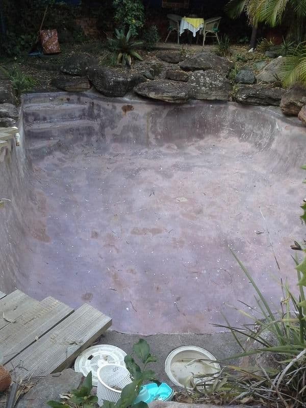 Fibreglass pool before - flaking, discoloured surface
